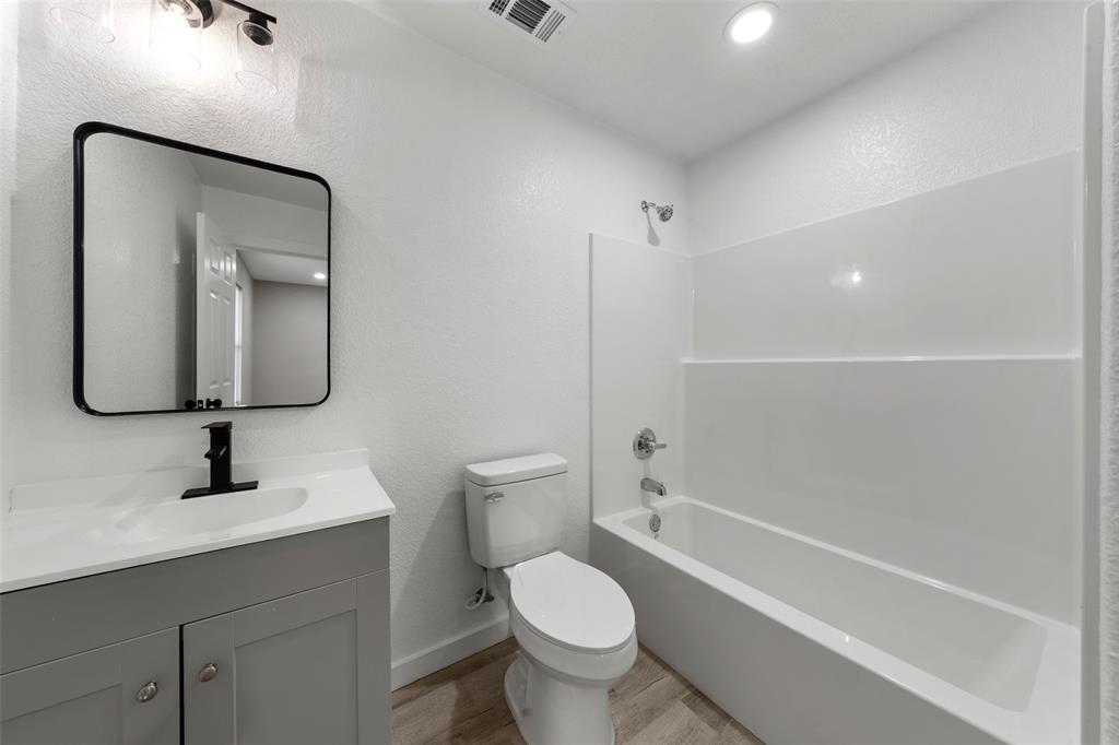 1905 Sanger Avenue Waco, TX 76707 - Photo 16 of 21 a bathroom with a toilet sink and mirror