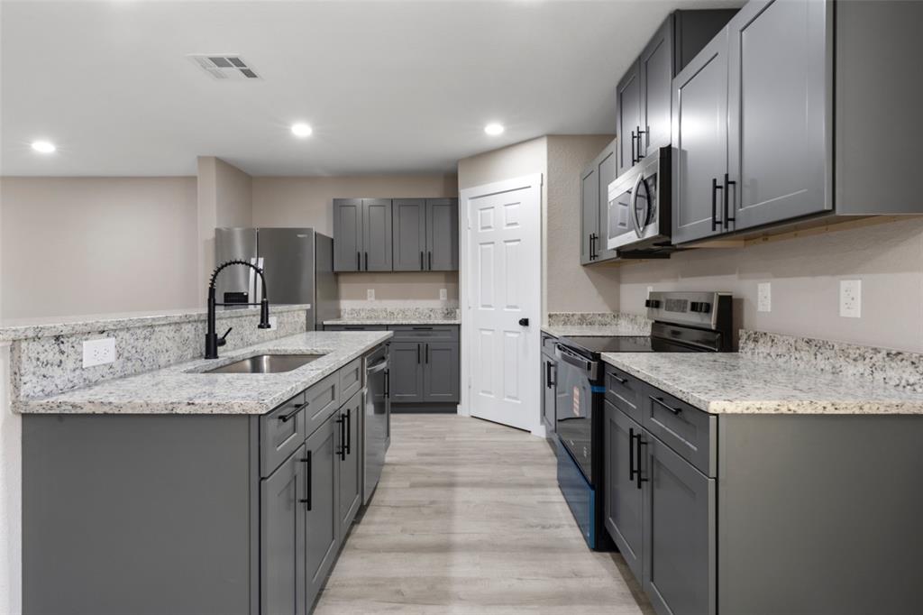 1905 Sanger Avenue Waco, TX 76707 - Photo 6 of 21 a kitchen with stainless steel appliances granite countertop a sink stove and cabinets