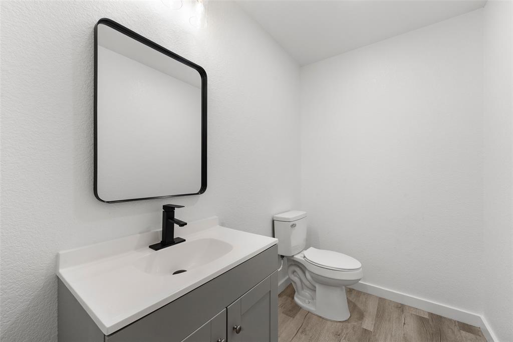 1905 Sanger Avenue Waco, TX 76707 - Photo 8 of 21 a bathroom with a toilet sink and mirror