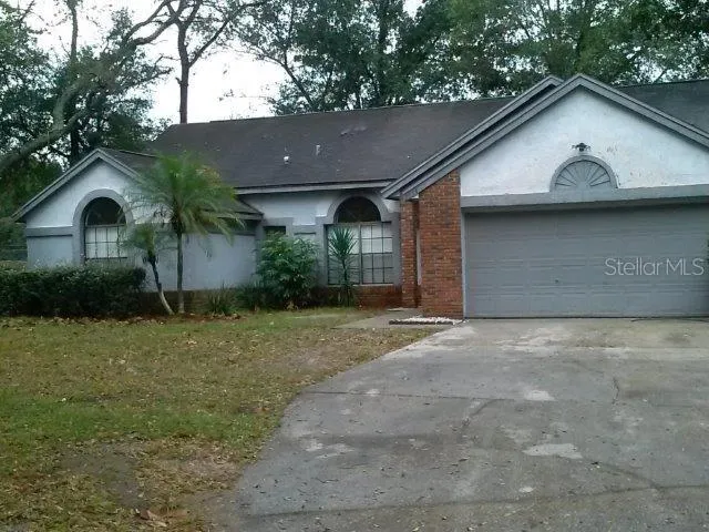 a view of a large house with a yard and garage