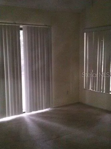 a bathroom with a granite countertop sink and a toilet