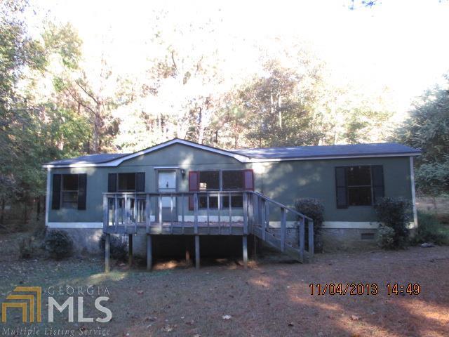 1231 City Pond Road Barnesville, GA 30204 - Photo 1 of 1 a front view of a house with a yard and garage