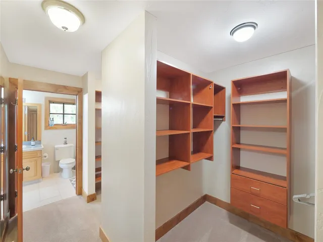 a bathroom with double vanity sinks a shower and a large mirror