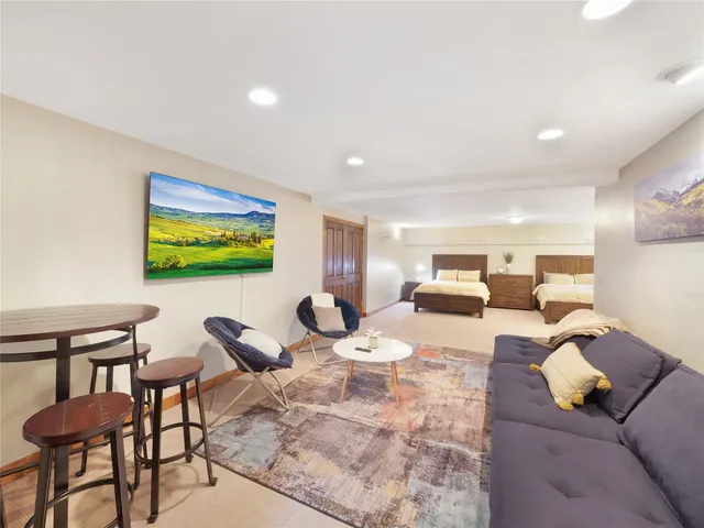 a bed room with a bed and a view of kitchen