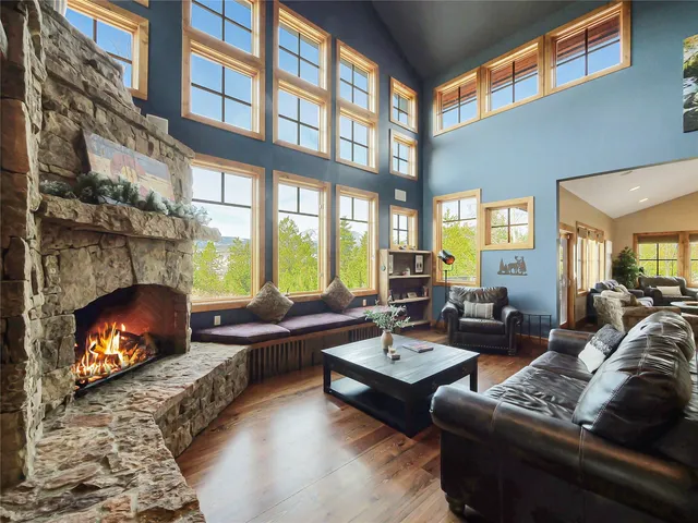 a living room with furniture fireplace and a large window