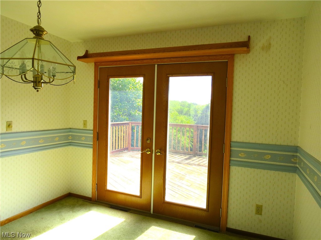 10130 Lee Road Minerva, OH 44657 - Photo 9 of 35 Dining room next to kitchen and living room. Double doors to 3 level deck. Wonderful views.
