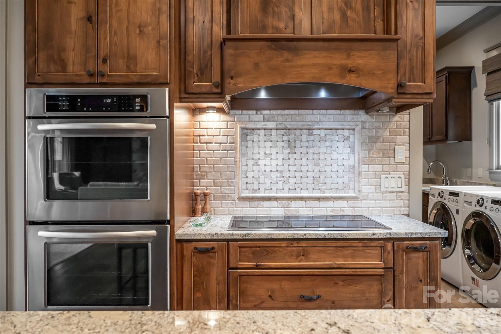 2 Cherokee Orchard Court Fairview, NC 28730 - Photo 14 of 47 a kitchen with granite countertop a stove and a sink