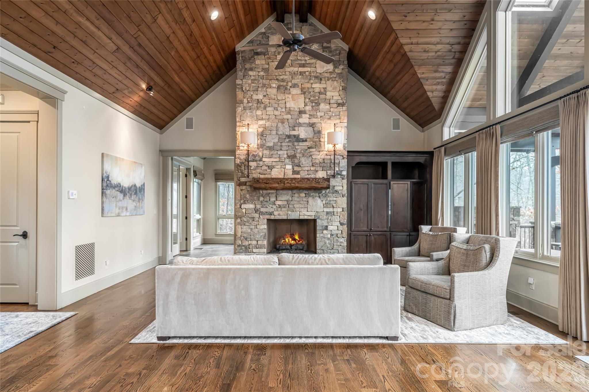 2 Cherokee Orchard Court Fairview, NC 28730 - Photo 9 of 47 a living room with furniture a fireplace and a chandelier