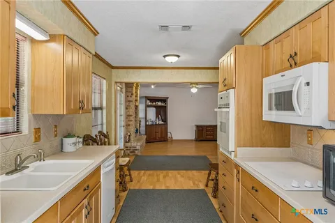 a spacious bathroom with a sink double vanity granite tub shower and a mirror
