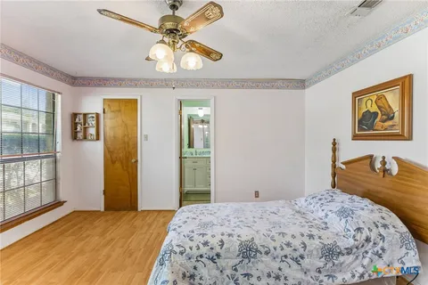 a bedroom with a bed and dresser