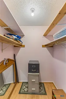 a view of storage and utility room with two washing machine