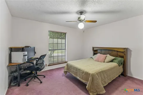 a bedroom with a bed a desk and chair