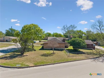 a view of a swimming pool with a yard