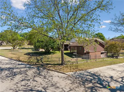 a view of a house with backyard of the house