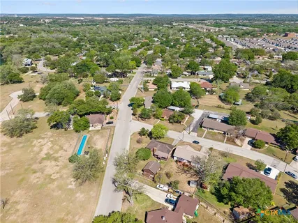 an aerial view of residential houses with outdoor space