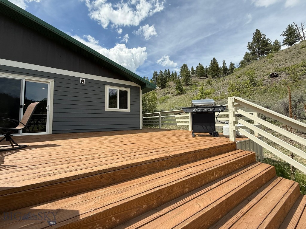 Huge outdoor deck that wraps around back for even more living space in summer & fall