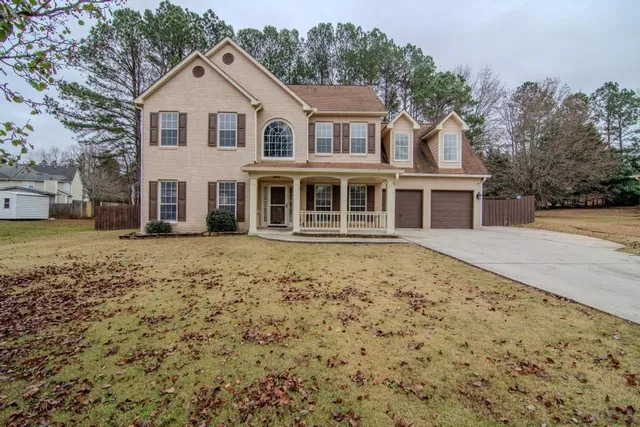 a front view of a house with a garden
