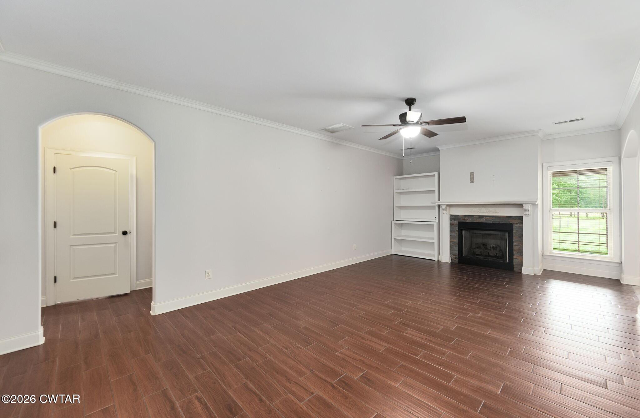 4080 Beech Bluff Road Beech Bluff, TN 38313 - Photo 24 of 41 an empty room with wooden floor fireplace and windows