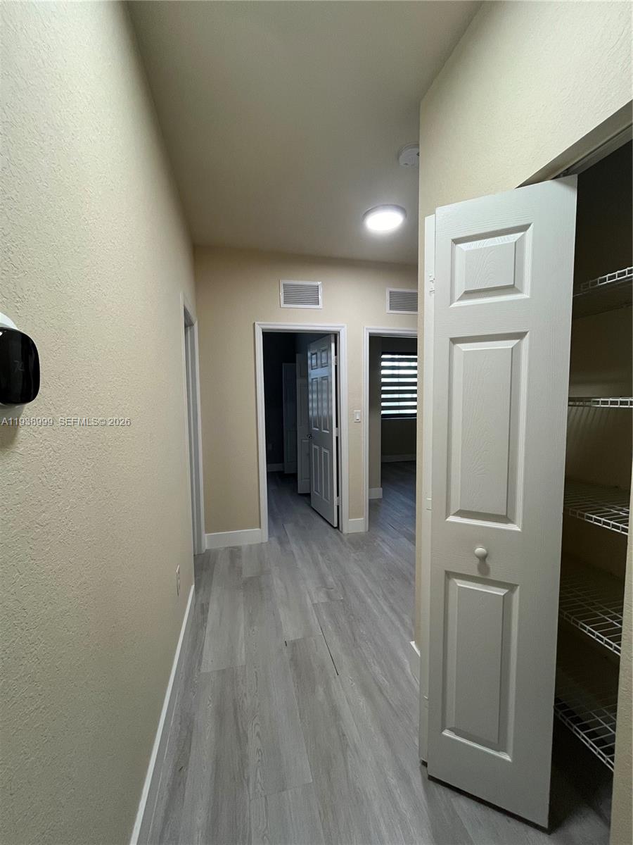 23218 Southwest 113 Passage Homestead, FL 33032 - Photo 12 of 23 wooden floor in an empty room