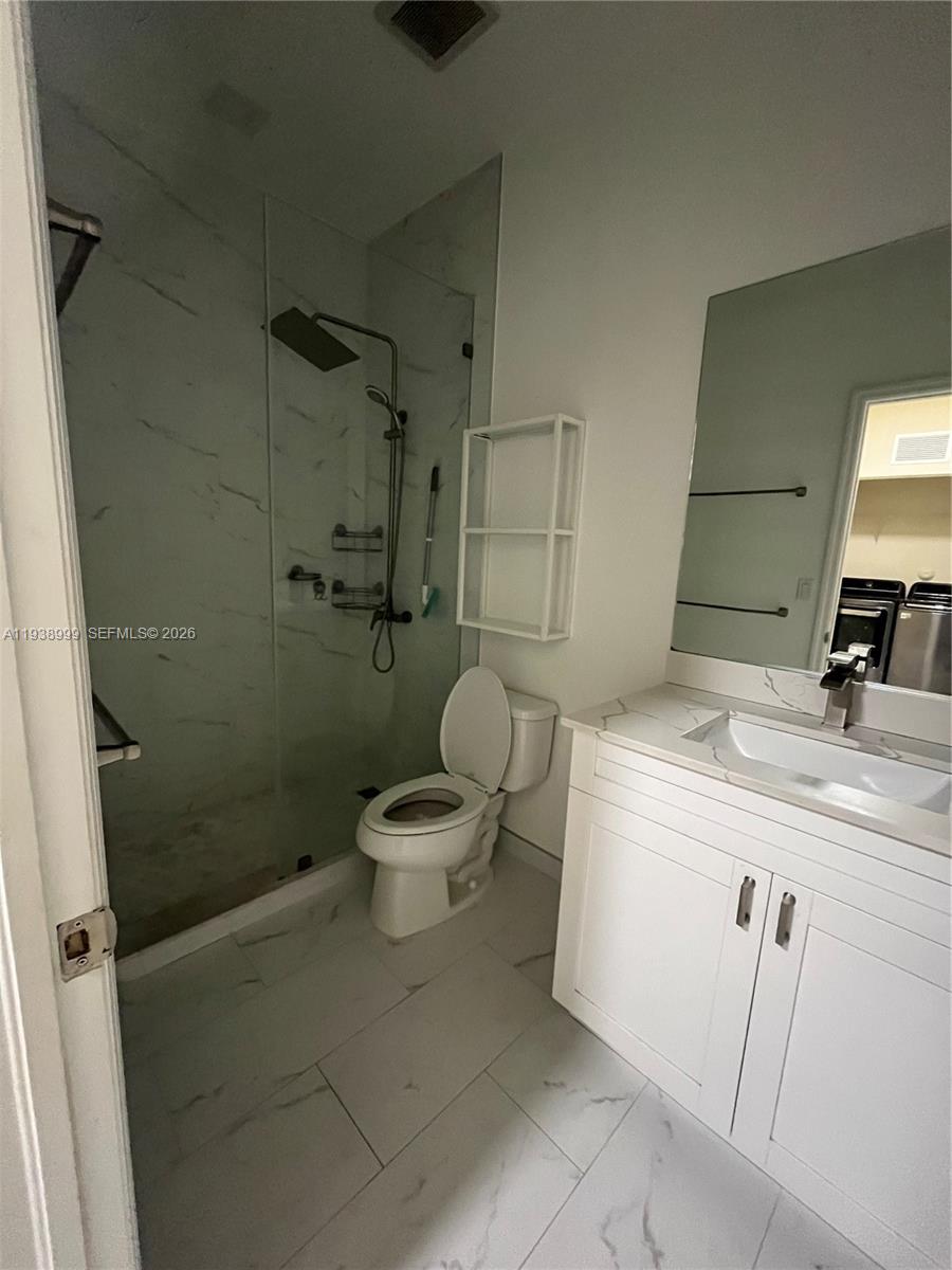 23218 Southwest 113 Passage Homestead, FL 33032 - Photo 14 of 23 a bathroom with a sink a toilet and a shower