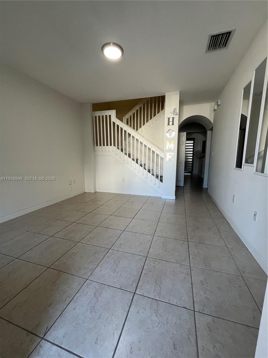 23218 Southwest 113 Passage Homestead, FL 33032 - Photo 2 of 23 a view of entryway with stairs and a window