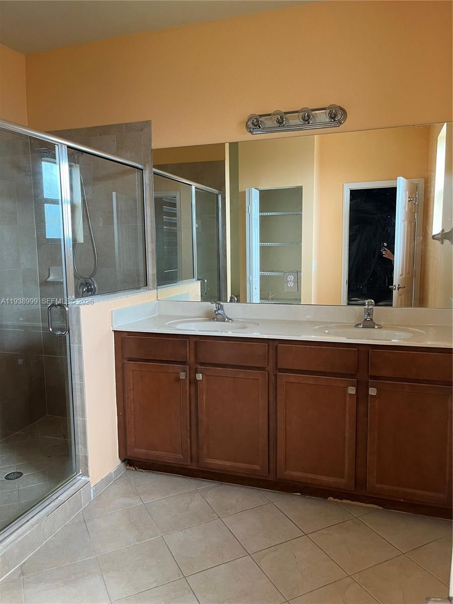 23218 Southwest 113 Passage Homestead, FL 33032 - Photo 8 of 23 a bathroom with a sink and a mirror