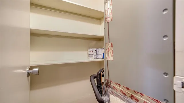 an empty room with wooden floor and door