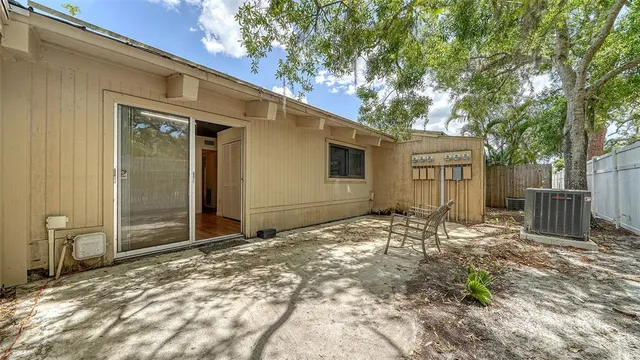 a view of a backyard with wooden fence