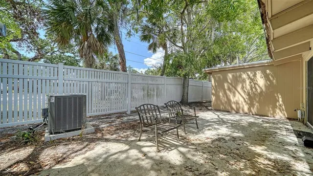 a view of a house with backyard and sitting area