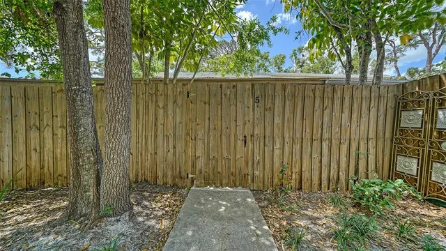 a view of a backyard with swimming pool