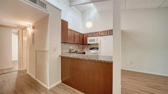 a kitchen with granite countertop cabinets and window