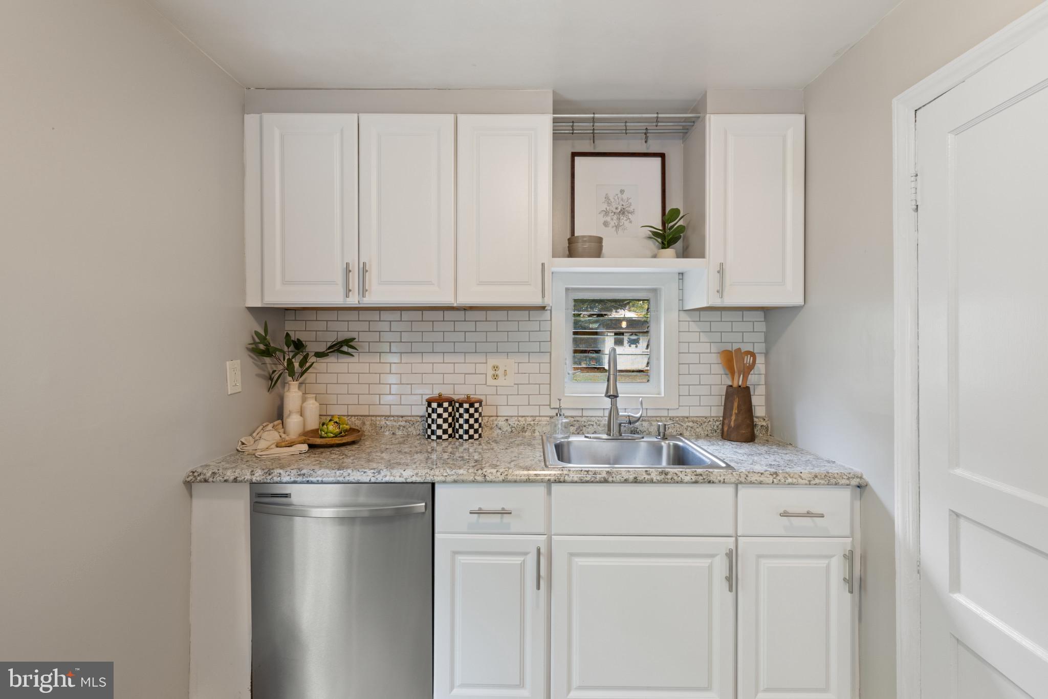 1326 Brook Road Baltimore, MD 21228 - Photo 8 of 35 a kitchen with white cabinets and a sink