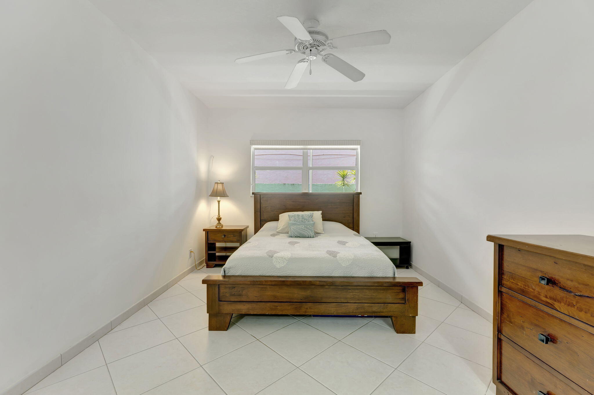 1450 North Riverside Drive, Unit 103 Pompano Beach, FL 33062 - Photo 14 of 34 a bedroom with a bed and window