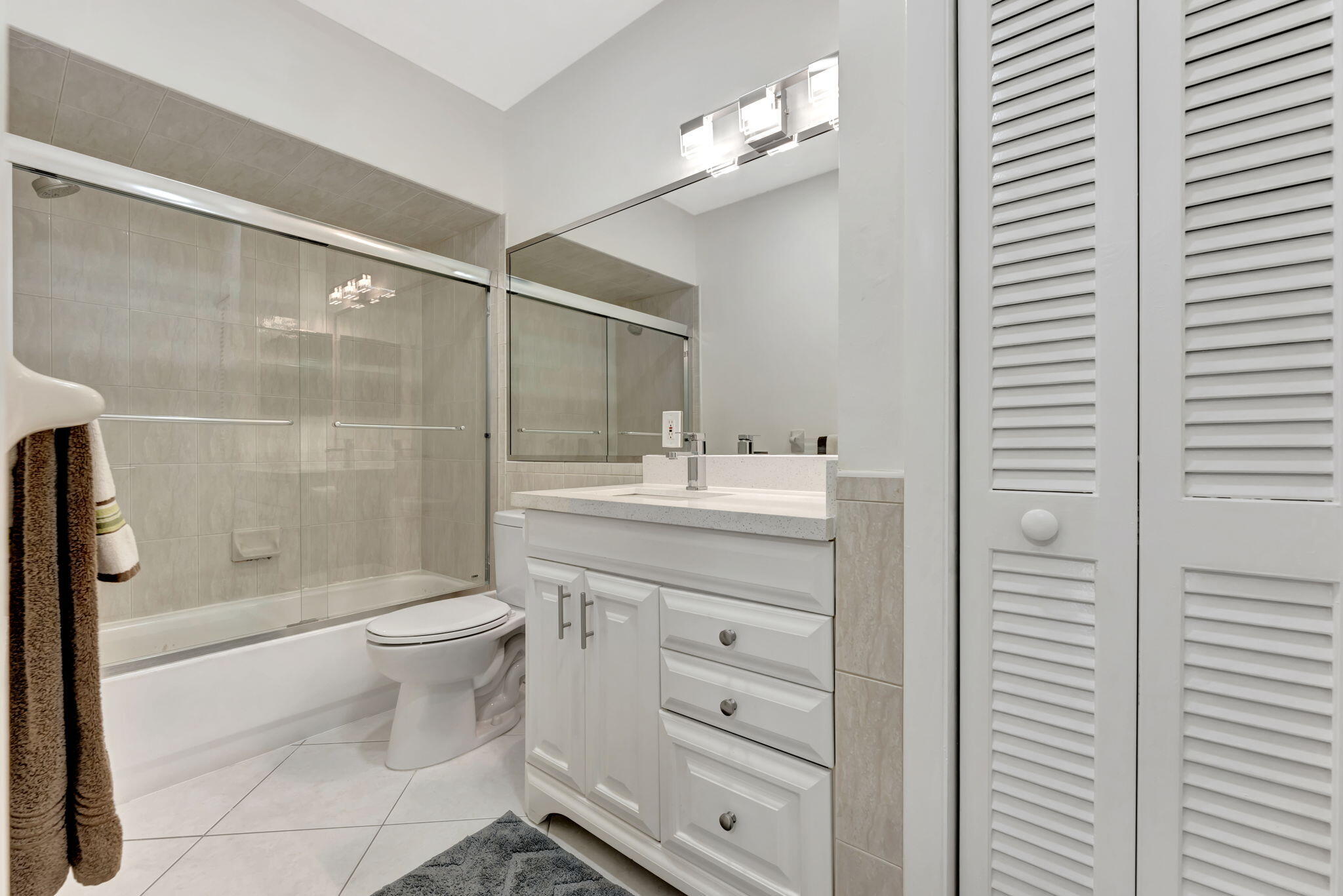 1450 North Riverside Drive, Unit 103 Pompano Beach, FL 33062 - Photo 17 of 34 a bathroom with a sink a toilet and shower