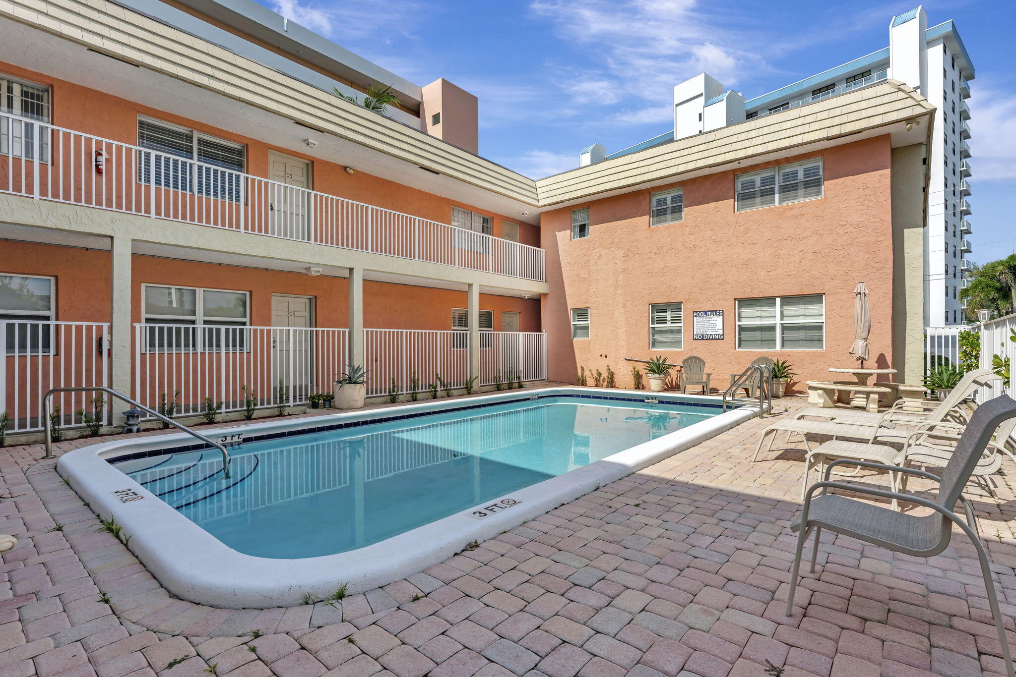 1450 North Riverside Drive, Unit 103 Pompano Beach, FL 33062 - Photo 22 of 34 a swimming pool with outdoor seating and yard