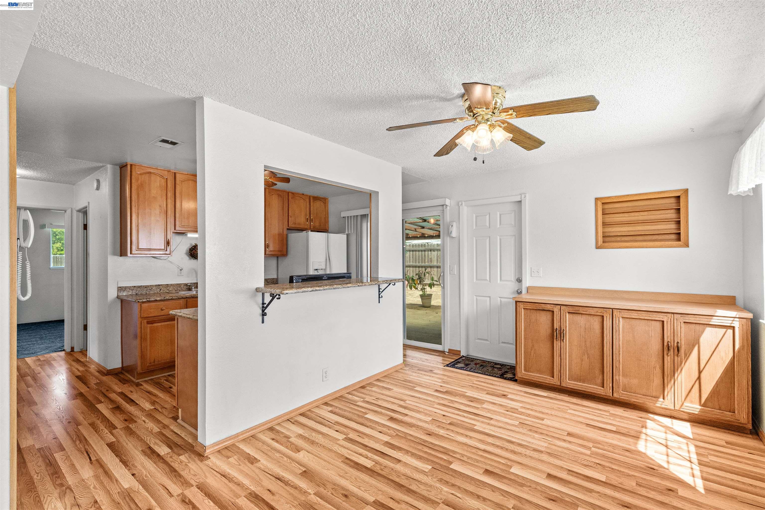 953 Thomsen Road Lathrop, CA 95330 - Photo 14 of 49 a view of a bedroom with wooden floor and a ceiling fan