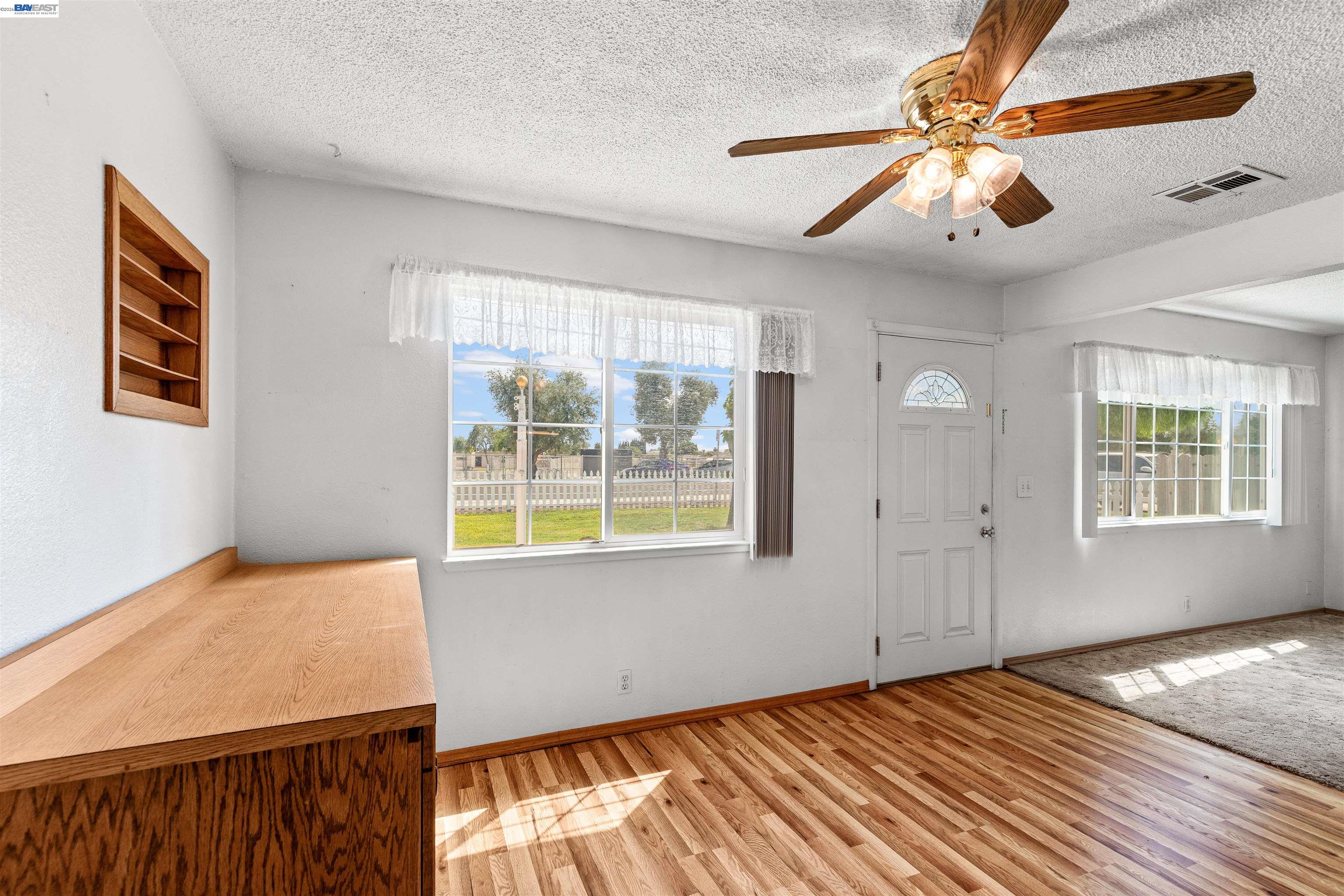953 Thomsen Road Lathrop, CA 95330 - Photo 15 of 49 a view of an empty room with window and wooden floor