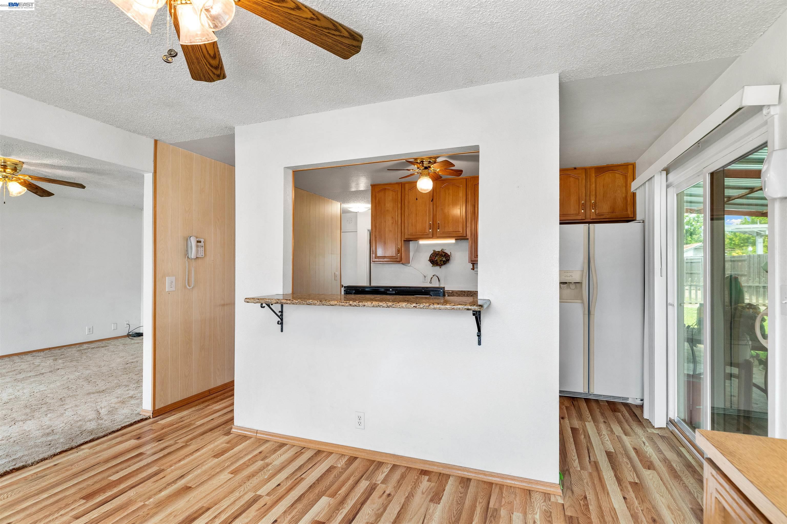 953 Thomsen Road Lathrop, CA 95330 - Photo 16 of 49 a view of a hallway to a bedroom with wooden floor and windows