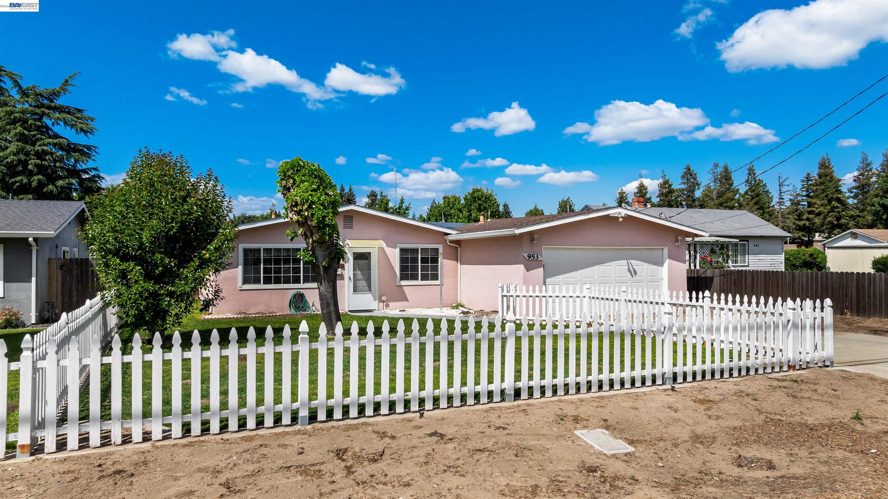 953 Thomsen Road Lathrop, CA 95330 - Photo 2 of 49 a front view of a house with a wrought fence
