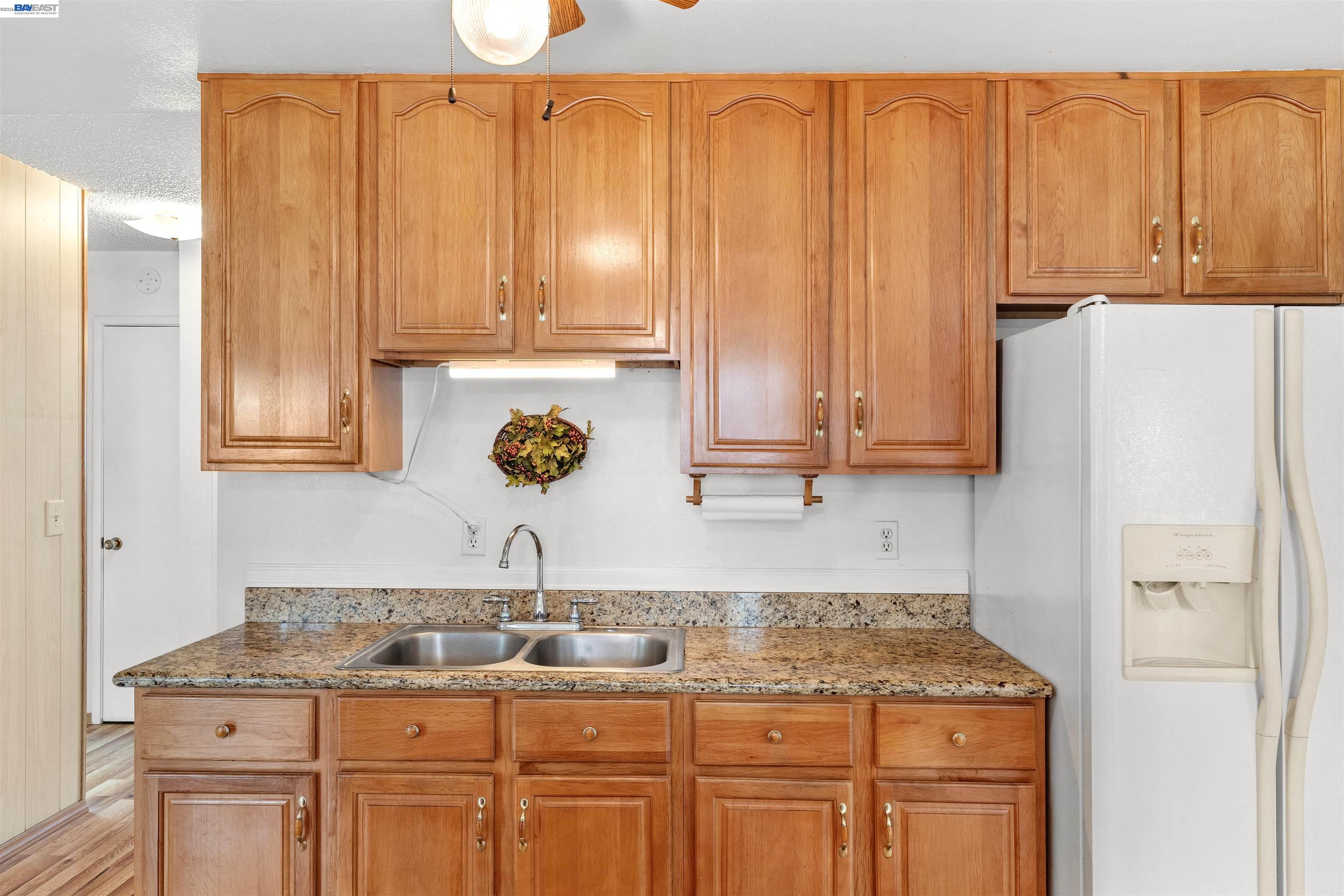 953 Thomsen Road Lathrop, CA 95330 - Photo 21 of 49 a kitchen with stainless steel appliances granite countertop a refrigerator and cabinets