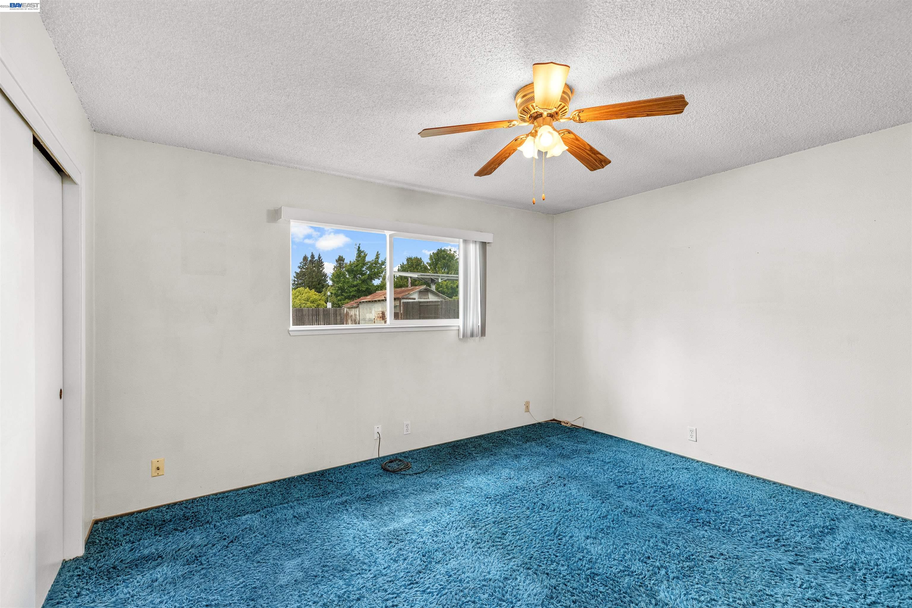 953 Thomsen Road Lathrop, CA 95330 - Photo 22 of 49 an empty room with windows and fan