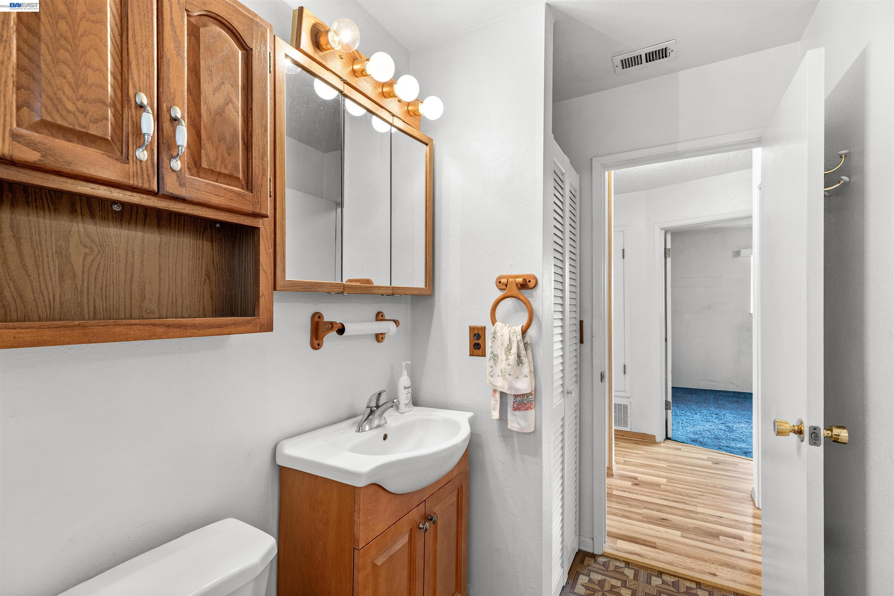 953 Thomsen Road Lathrop, CA 95330 - Photo 25 of 49 a bathroom with a sink a toilet and mirror