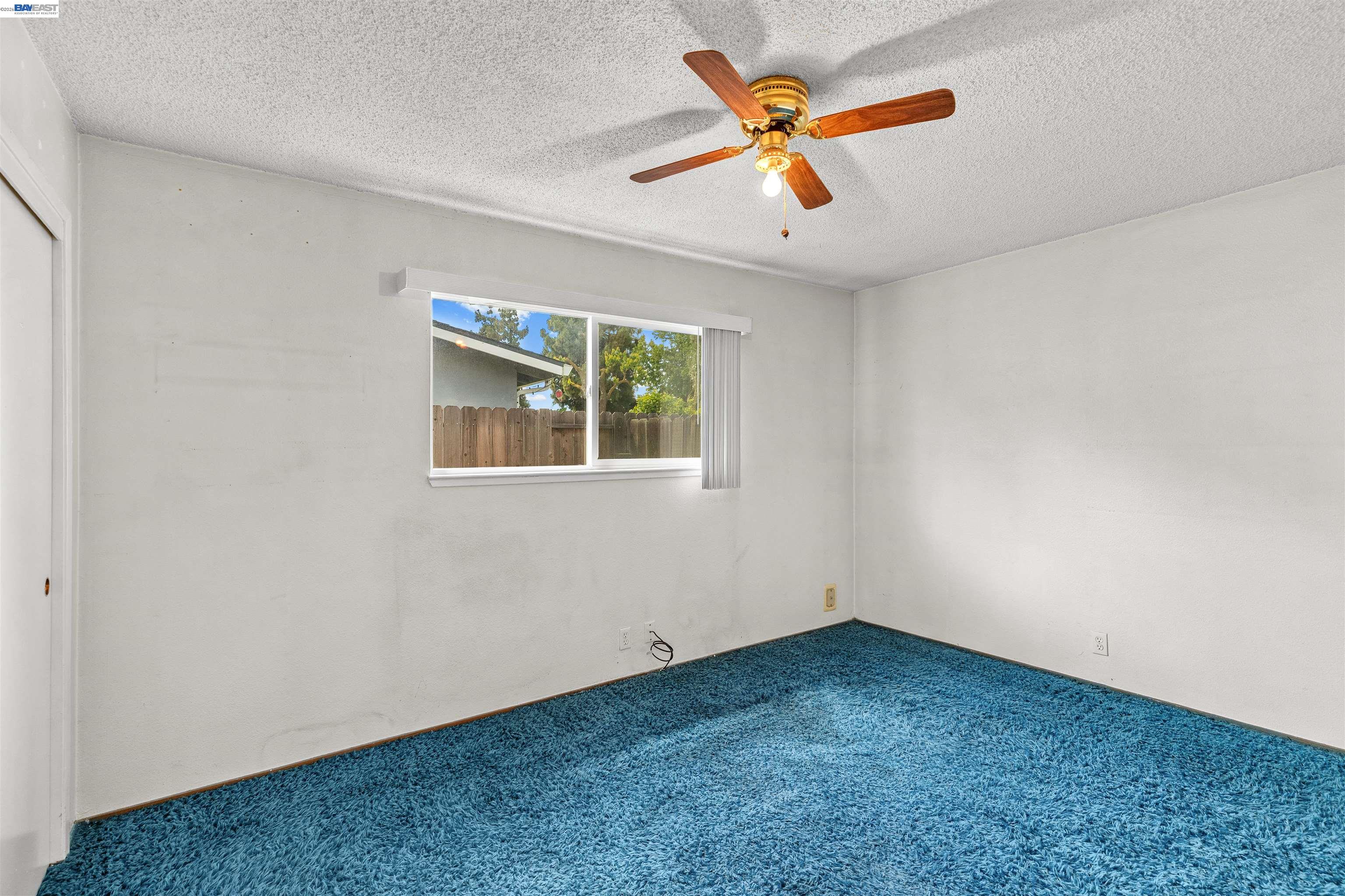 953 Thomsen Road Lathrop, CA 95330 - Photo 26 of 49 an empty room with a window and a ceiling fan