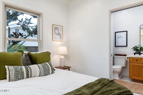 a bathroom with a granite countertop toilet sink and mirror
