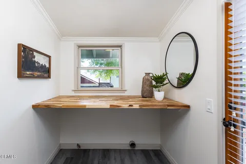 a living room with furniture and a mirror