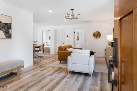 a kitchen with stainless steel appliances granite countertop a stove a sink and white cabinets