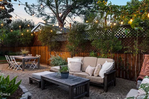 a balcony with furniture and potted plants