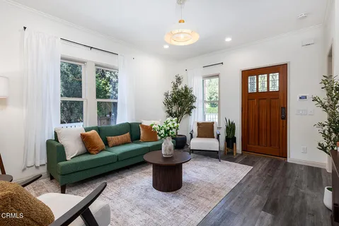 a kitchen with stainless steel appliances granite countertop a table chairs sink and cabinets