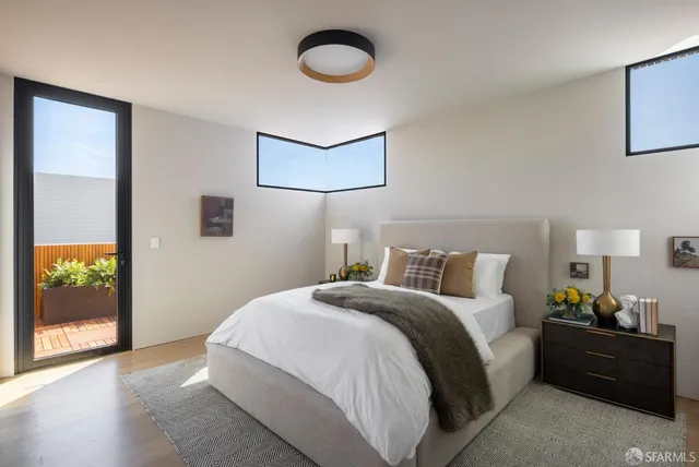 a bedroom with a bed and painting on the wall