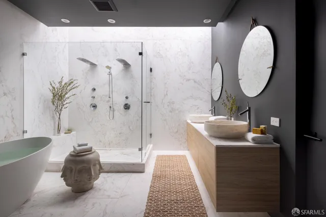 a bathroom with a tub sink and mirror